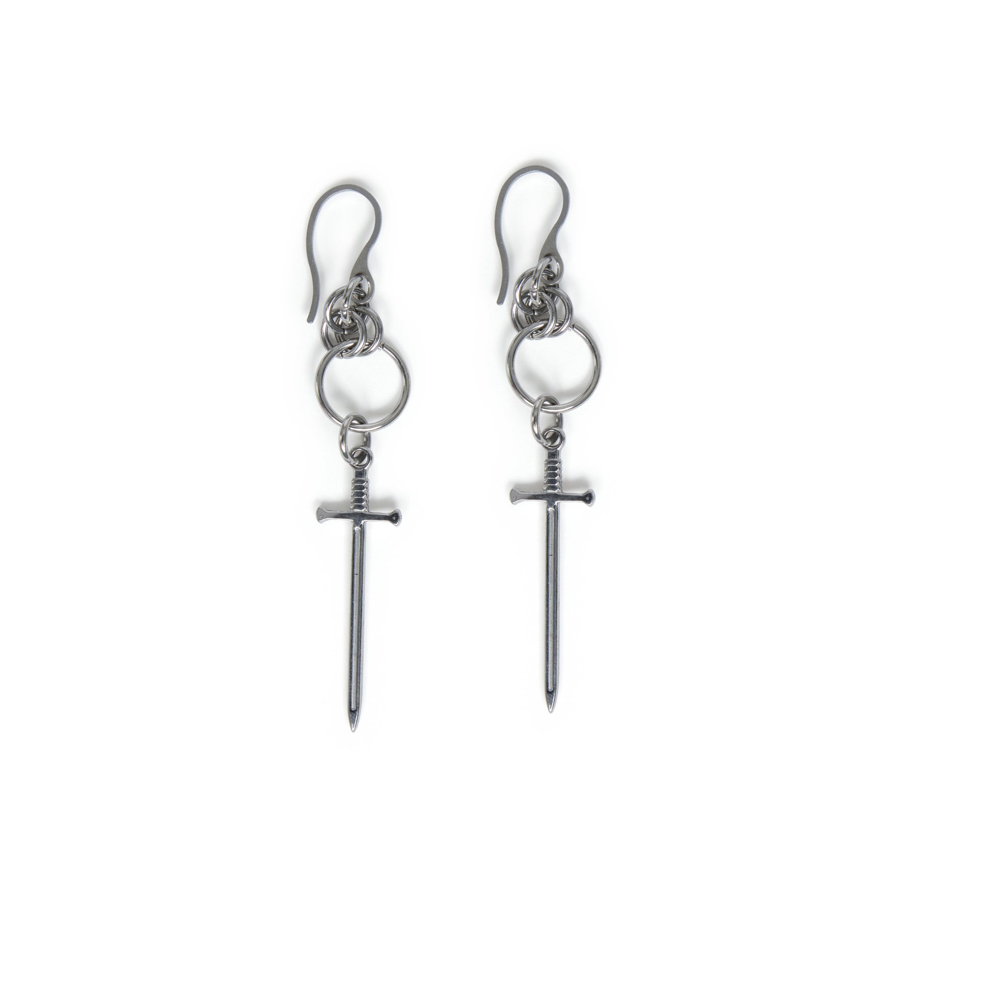 Pair of stainless steel earrings with chainmail detail and dangling sword charms on a white background