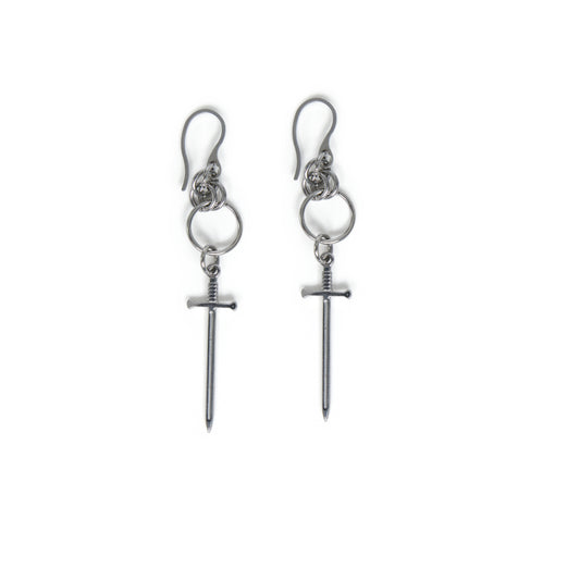 Pair of stainless steel earrings with chainmail detail and dangling sword charms on a white background