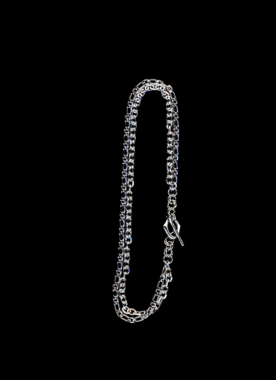 Stainless steel chain necklace with double chain strand and organic toggle closure on a black background