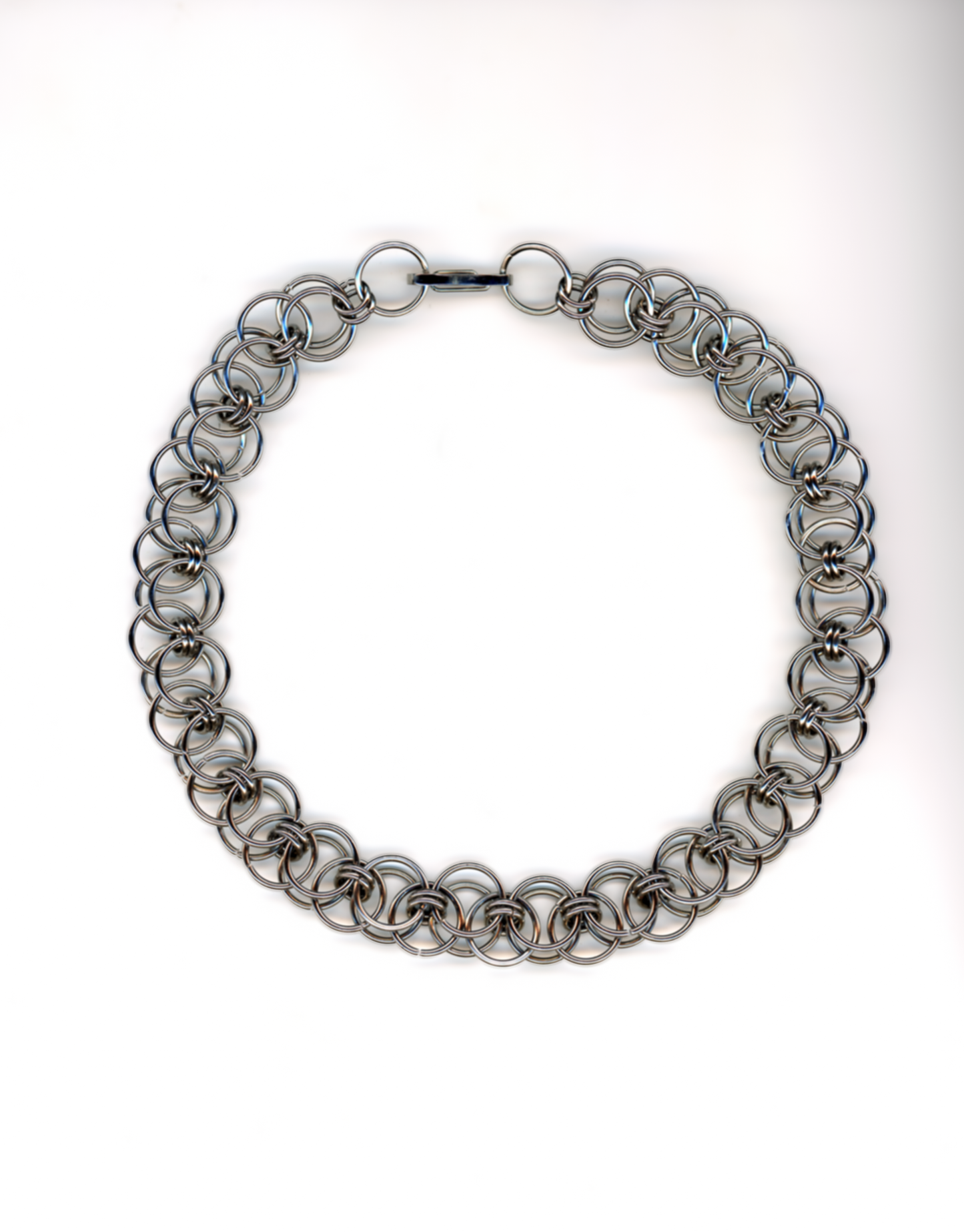 Silver chainmail necklace on a white background