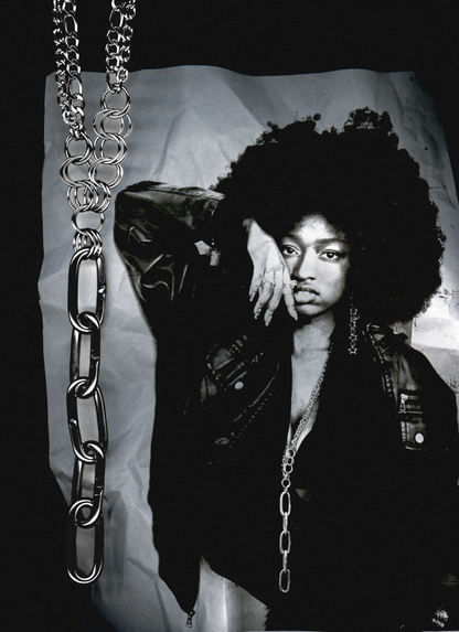 black and white photocopy scan edit of person with large afro and chain necklace against a plain background with the same chain overlayed in the scan.