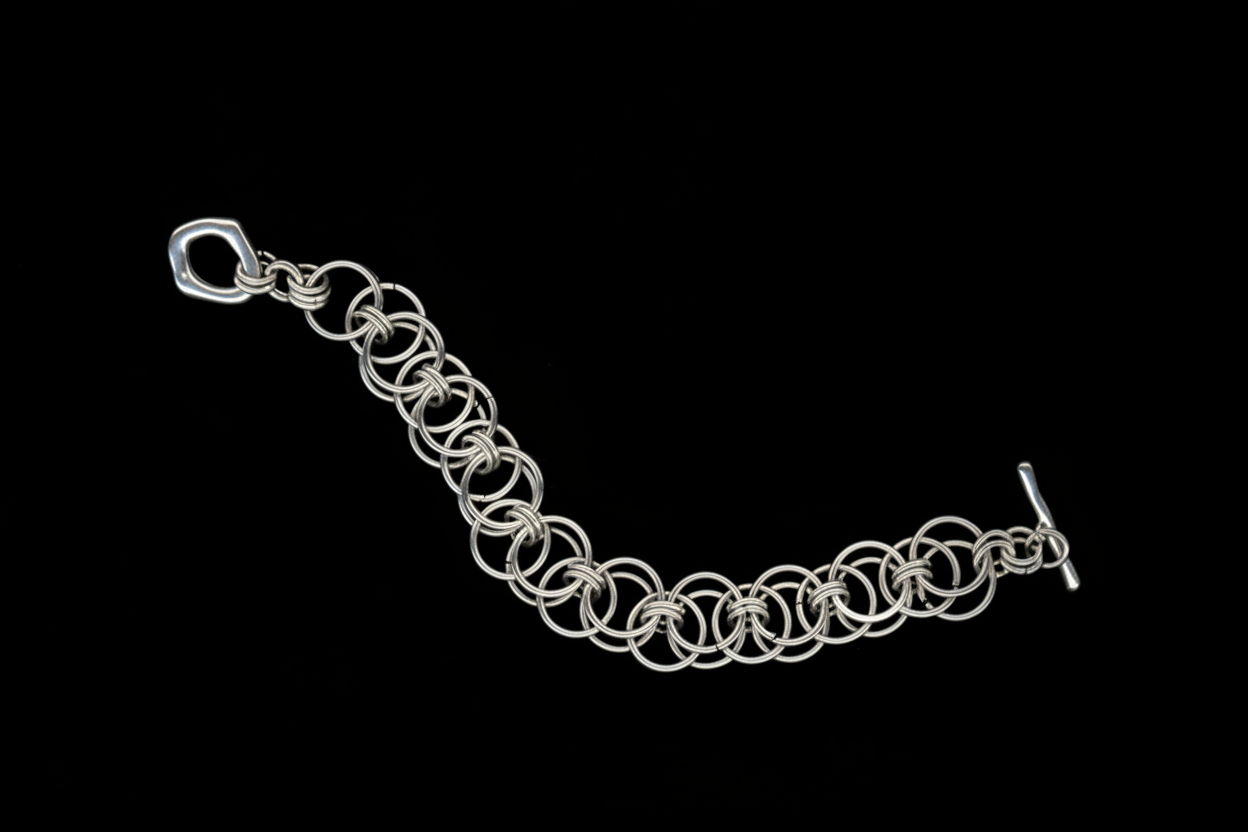 Silver chain bracelet on a black background