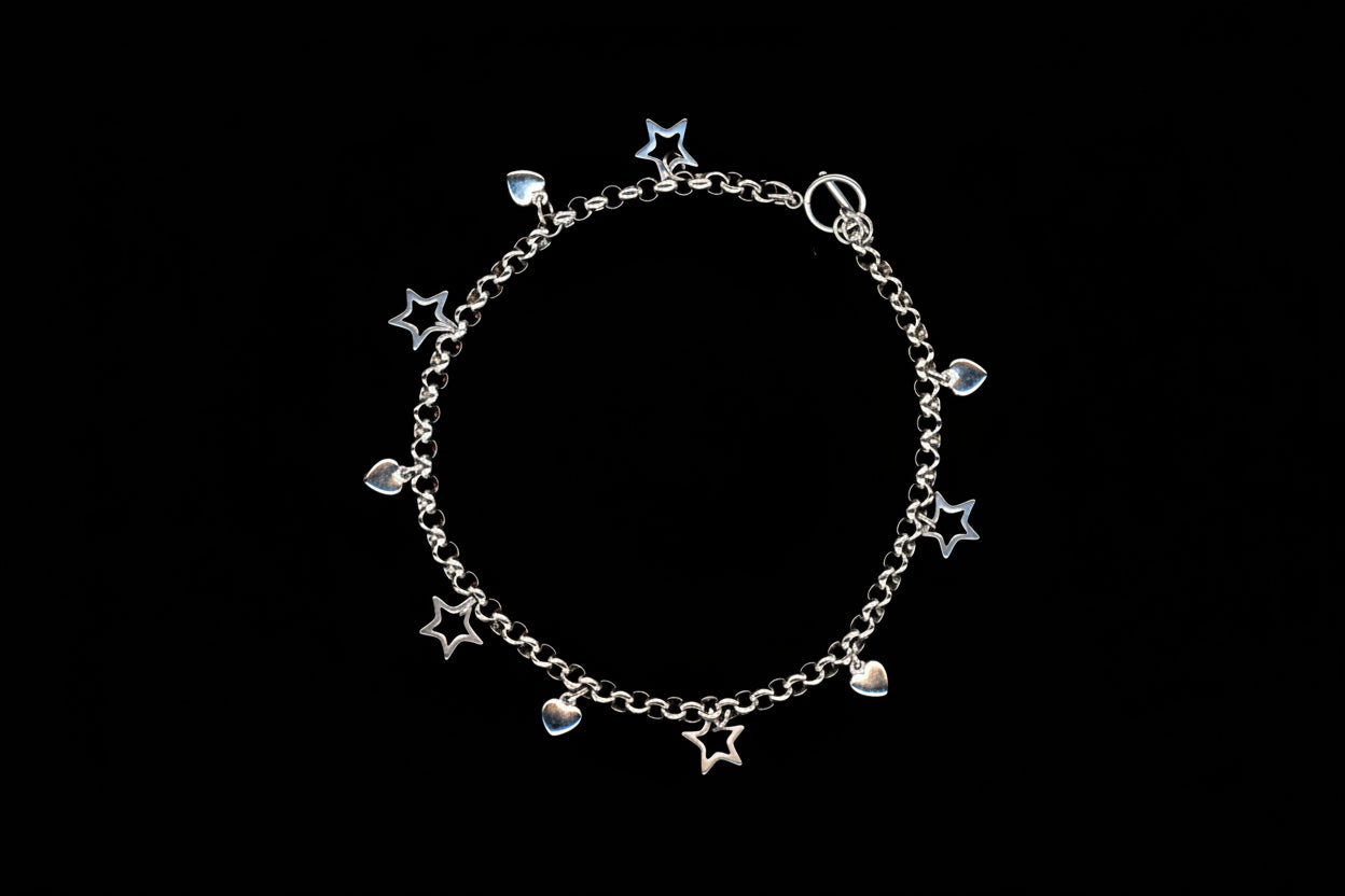 A silver stainless steel charm necklace with heart and star charms, presented against a black background.