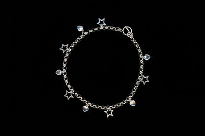 A silver stainless steel charm necklace with heart and star charms, presented against a black background.