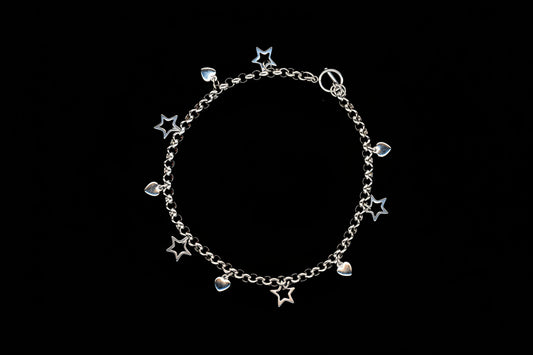 A silver stainless steel charm necklace with heart and star charms, presented against a black background.