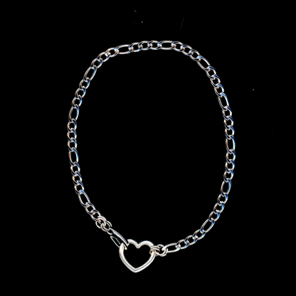 A silver choker necklace with a heart-shaped clasp on a black background.