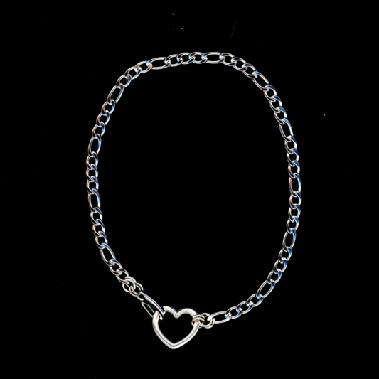 A silver choker necklace with a heart-shaped clasp on a black background.