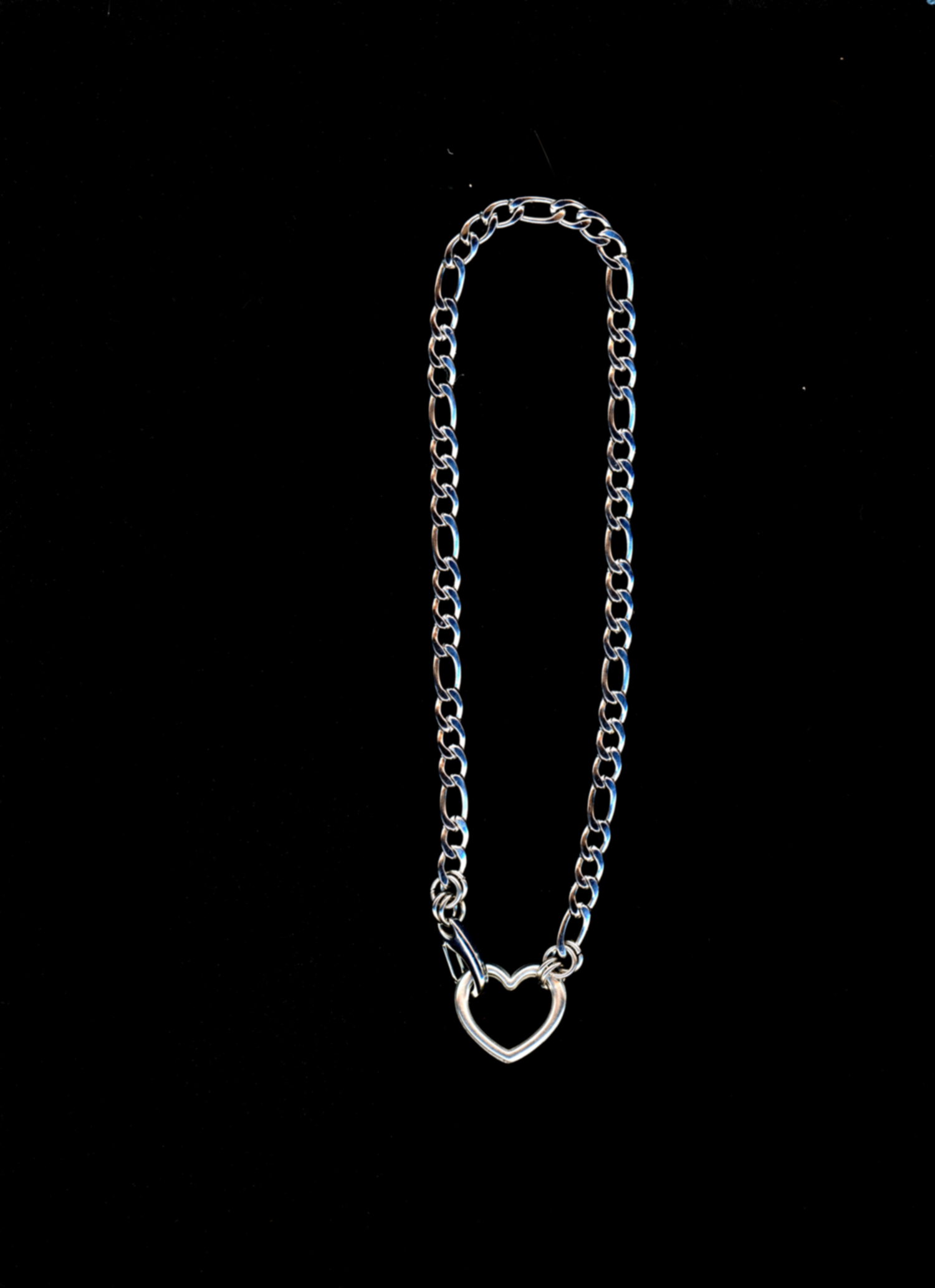 A silver choker necklace with a heart-shaped clasp on a black background.