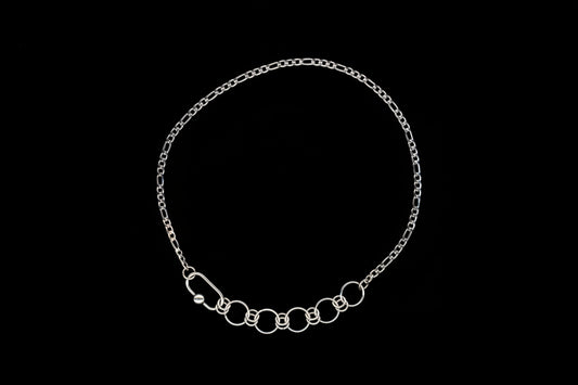 Silver chain necklace with chainmail detail on a black background