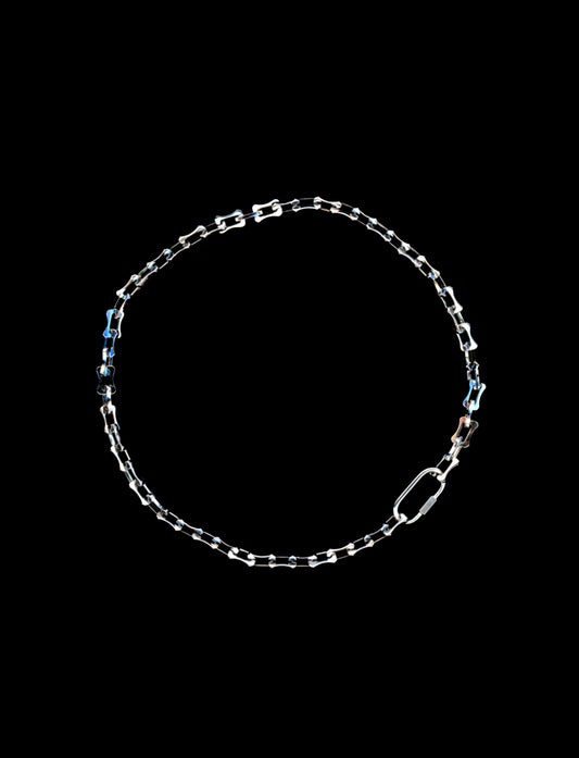 Silver chain necklace on a black background