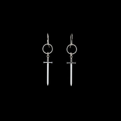 Silver sword-shaped earrings on a black background