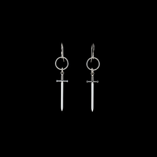 Silver sword-shaped earrings on a black background
