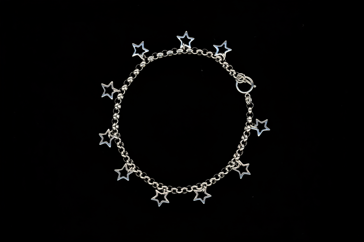A silver charm necklace with hollow star charms attached to a chunky rolo chain, displayed against a black background.
