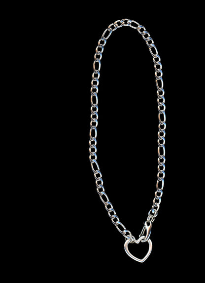 Silver chain necklace with a heart-shaped closure on a black background
