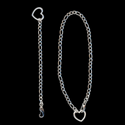 Silver chain necklace and bracelet with heart-shaped closures on a black background