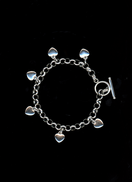 Silver bracelet with heart-shaped charms on a black background